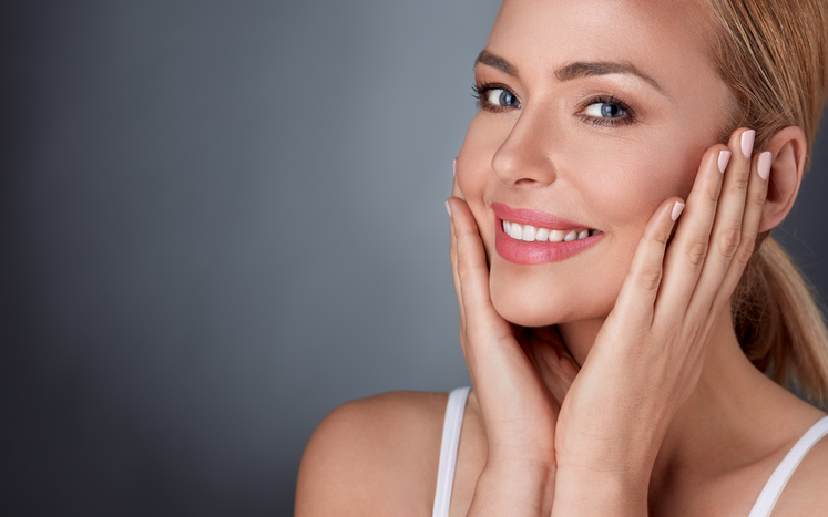 Injectables Smiling woman enjoying in her healthy skin